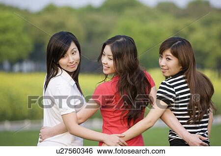 Three young women looking over on shoulder View Large Photo Image Stock Photograph - Three young women looking over on shoulder. Fotosearch