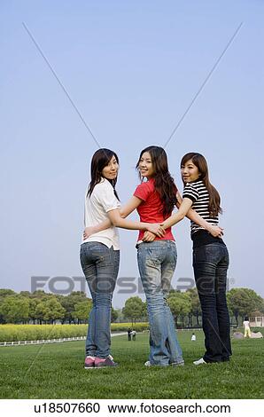 Three young women standing on the lawn with hands on hip View Large Photo Image Stock Image - Three young women standing on the lawn with hands on hip. Fotosearch