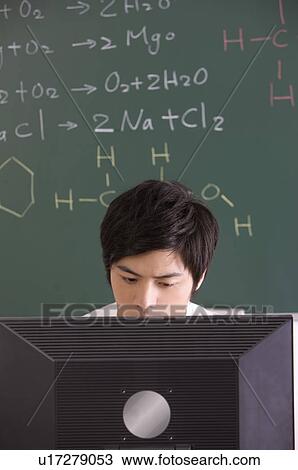 Young man sitting in the classroom and using computer, Studying, Education View Large Photo Image Stock Image - Young man sitting in the classroom and using computer, Studying, Education. Fotosearch
