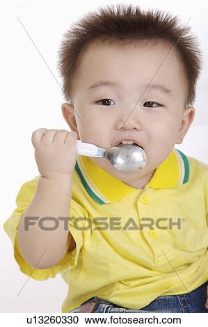 baby holding spoon