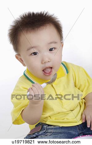 baby holding spoon