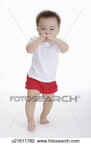 Baby boy walking with finger in mouth, Child View Large Photo Image Stock Image - Baby boy walking with finger in mouth, Child. Fotosearch