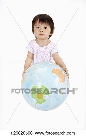 Baby girl sitting and holding a globe, Child View Large Photo Image Stock Photo - Baby girl sitting and holding a globe, Child. Fotosearch