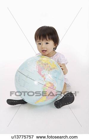Baby girl sitting with globe and smiling happily, Child View Large Photo Image Stock Photo - Baby girl sitting with globe and smiling happily, Child. Fotosearch