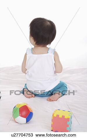 Baby girl sitting with toy and playing, Child View Large Photo Image Stock Image - Baby girl sitting with toy and playing, Child. Fotosearch