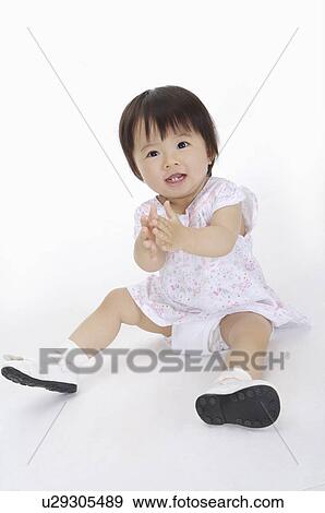 Baby girl sitting with toy and smiling, Child View Large Photo Image Stock Photo - Baby girl sitting with toy and smiling, Child. Fotosearch