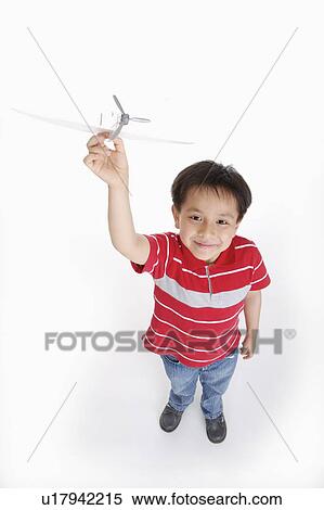 Boy holding an aircraft and looking up, Child View Large Photo Image Stock Photography - Boy holding an aircraft and looking up, Child. Fotosearch