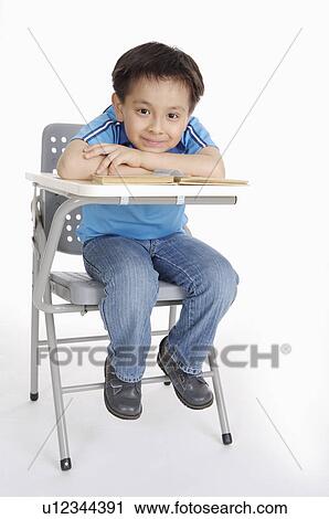 Boy sitting on the chair and looking at the camera, Child View Large Photo Image Stock Image - Boy sitting on the chair and looking at the camera, Child. Fotosearch