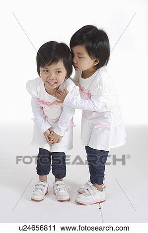 Two little girls standing together and talking, Child View Large Photo Image Stock Image - Two little girls standing together and talking, Child. Fotosearch