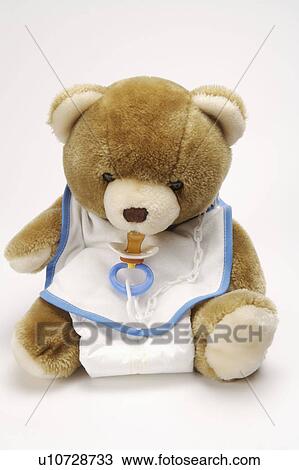 A teddy bear dressed like a baby View Large Photo Image Stock Image - A teddy bear dressed like a baby. Fotosearch