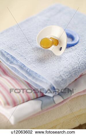 Pacifier on towels View Large Photo Image Stock Image - Pacifier on towels. Fotosearch