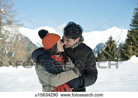 Couple embracing in winter scene View Large Photo Image Stock Image - Couple embracing in winter scene. Fotosearch