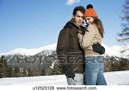 Stock Photo - Couple embracing in winter scene. Fotosearch