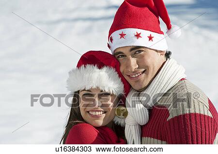 Couple in Christmas outfit embracing View Large Photo Image Stock Image - Couple in Christmas outfit embracing. Fotosearch
