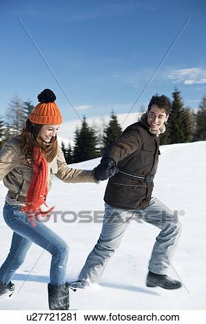 Couple running in winter scene View Large Photo Image Stock Image - Couple running in winter scene. Fotosearch