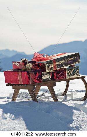 Stock Image - Sleigh with presents in snowy landscape. Fotosearch