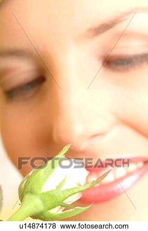 Stock Photo - Close-up of female face with single white rose. Fotosearch