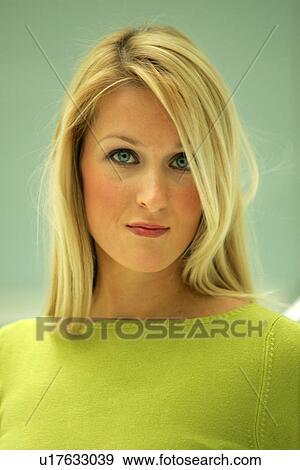 Stock Photo - Portrait of young business woman with long blond hair wearing green sweater. Fotosearch