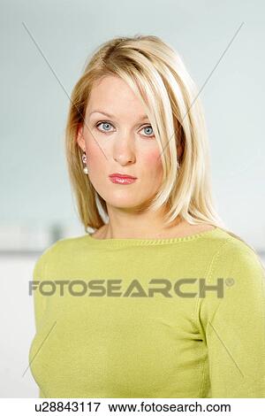 Portrait of young business woman with long blond hair wearing green sweater, waist-up View Large Photo Image Stock Photo - Portrait of young business woman with long blond hair wearing green sweater, waist-up. Fotosearch