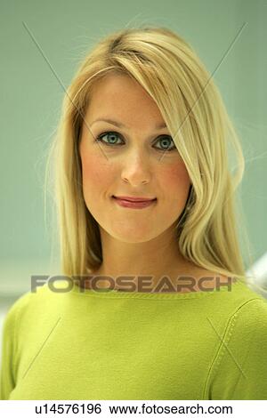 Stock Photograph - Portrait of young business woman with long blond hair wearing green sweater. Fotosearch