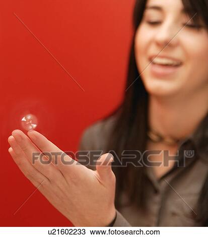 Stock Image - A bubble on her fingertip. Fotosearch