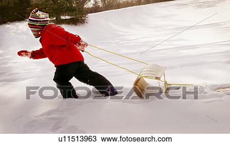 Stock Image - A child out sledging. Fotosearch