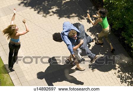 Stock Photo - A group of friends dancing about. Fotosearch