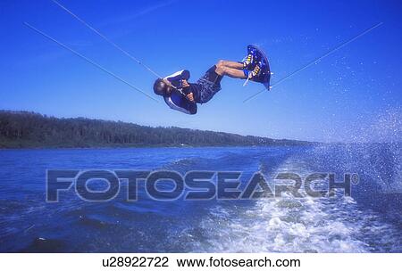 Stock Image - A wake boarder trick. Fotosearch