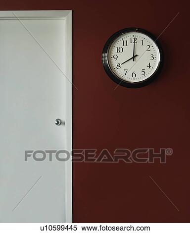 Stock Photography - A wall clock showing 8 o'clock. Fotosearch