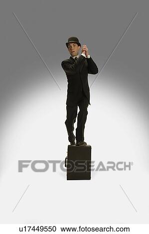 A winning businessman stands on his briefcase View Large Photo Image Stock Image - A winning businessman stands on his briefcase. Fotosearch