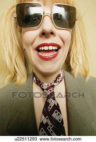 Stock Image - A woman with square glasses. Fotosearch