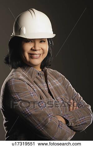 Stock Image - Aboriginal woman wearing hard hat. Fotosearch