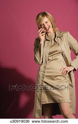 Attractive woman on her cell phone View Large Photo Image Stock Photograph - Attractive woman on her cell phone. Fotosearch