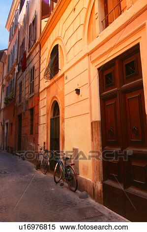 Stock Photography - Bicycles on street in front of Buildings Rome Italy . Fotosearch