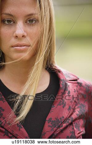 Stock Photo - Blonde wearing red and black jacket. Fotosearch