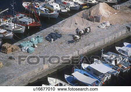 Stock Image - Boats at harbor. Fotosearch