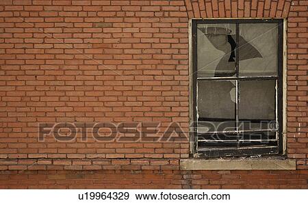 Stock Photo - Brick building with broken window. Fotosearch