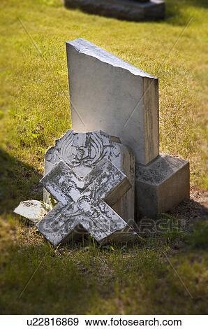 Stock Photo - Broken headstone in cemetery. Fotosearch