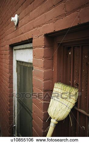 Broom leaning against an exterior wall View Large Photo Image Stock Photograph - Broom leaning against an exterior wall. Fotosearch