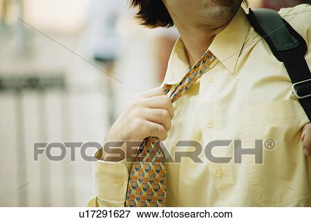 Stock Photo - Businessman grips tie. Fotosearch