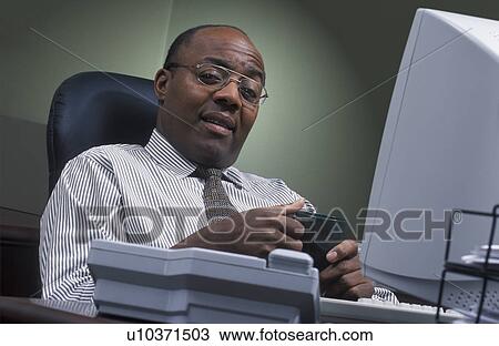 Stock Image - Businessman hopeful about the day's work. Fotosearch