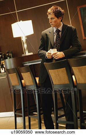 Stock Image - Businessman waiting with cup of coffee. Fotosearch