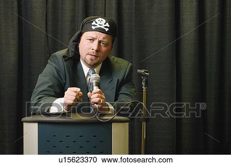 Stock Image - Businessman wearing pirate headgear. Fotosearch