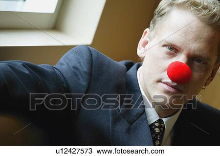 Businessman wearing red nose View Large Photo Image Stock Image - Businessman wearing red nose. Fotosearch