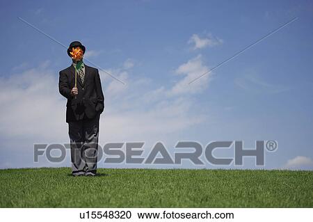 Stock Image - Businessman with a windmill. Fotosearch