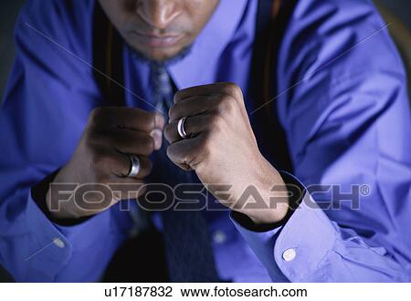 Stock Image - Businessman with fists raised. Fotosearch