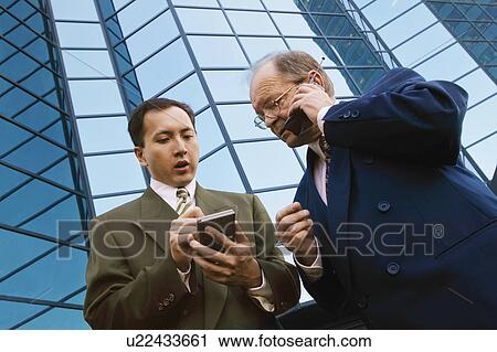Businessmen outside office building View Large Photo Image Stock Image - Businessmen outside office building. Fotosearch
