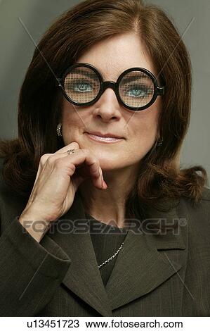 Stock Image - Businesswoman in silly glasses. Fotosearch