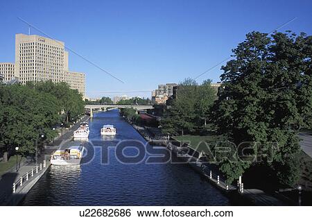 Canal flowing through a city View Large Photo Image Stock Photograph - Canal flowing through a city. Fotosearch