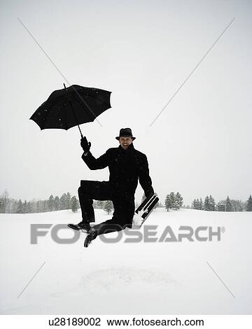 Carefree businessman in the snow View Large Photo Image Stock Image - Carefree businessman in the snow. Fotosearch